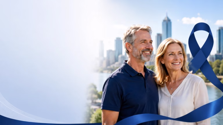 Mature Brisbane couple smiling outdoors beside a navy bowel cancer awareness ribbon with the city skyline behind them