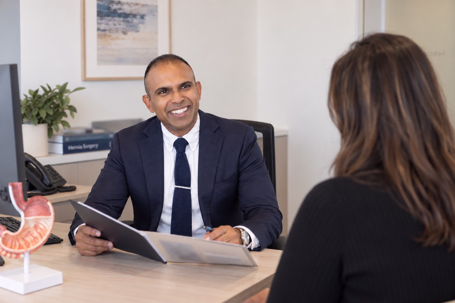 Dr Goutham speaking with a patient during a consultation