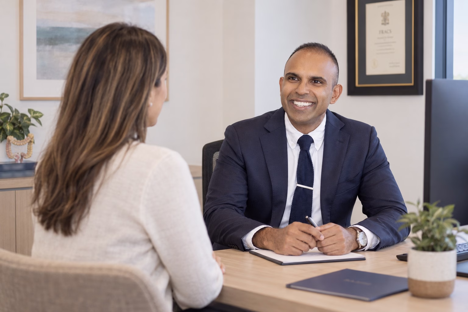Dr Goutham reviewing previous operation information during a consultation